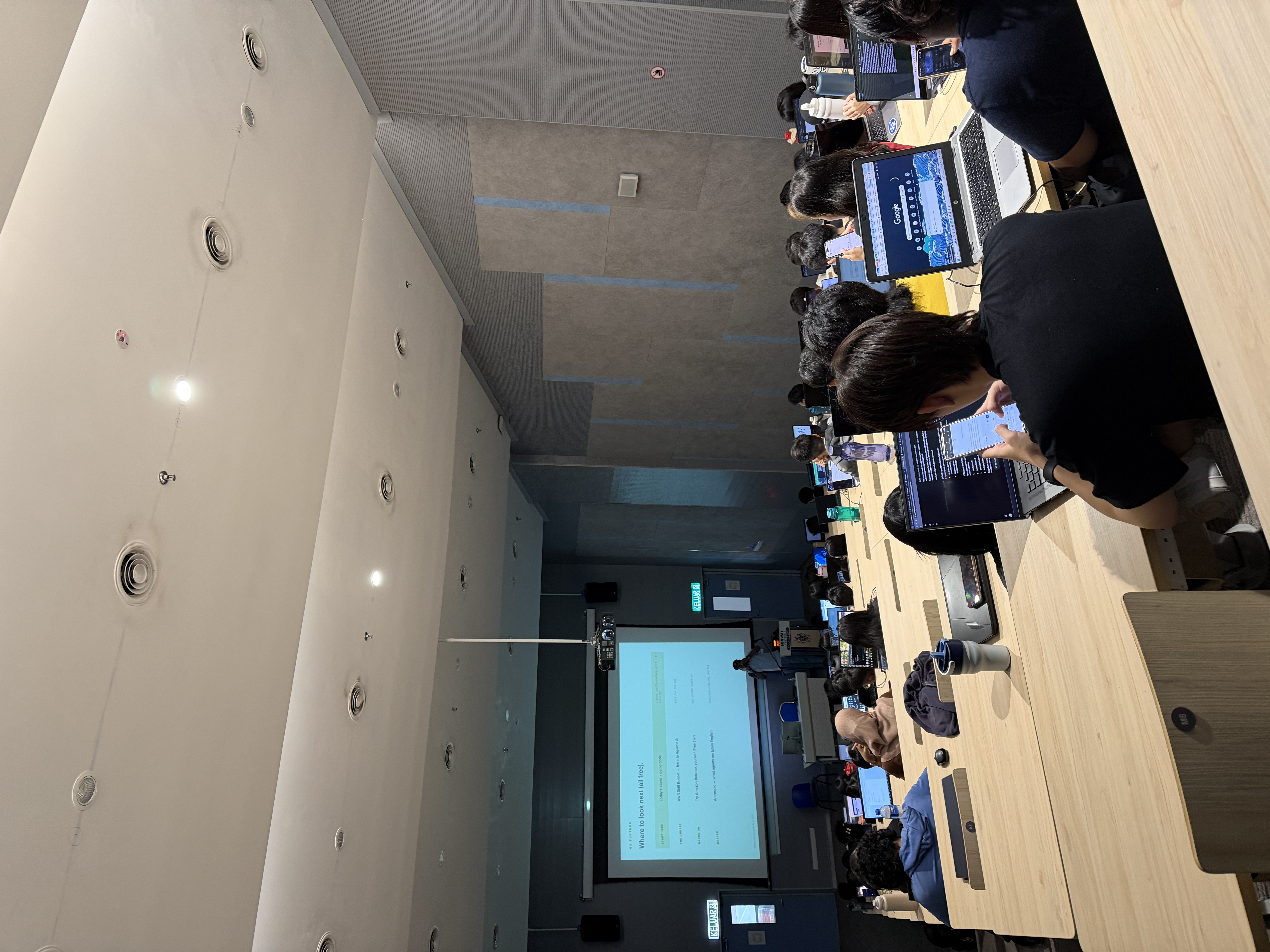 View from the back of a packed Sunway University lecture theatre, students with laptops open